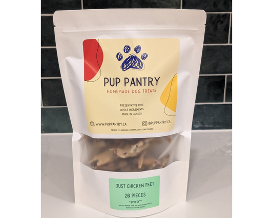 Pup Pantry homemade dog treats packaging with visible chicken feet inside on a tiled background